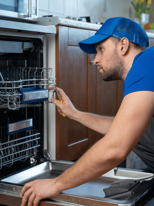 plumber installing a dishwasher