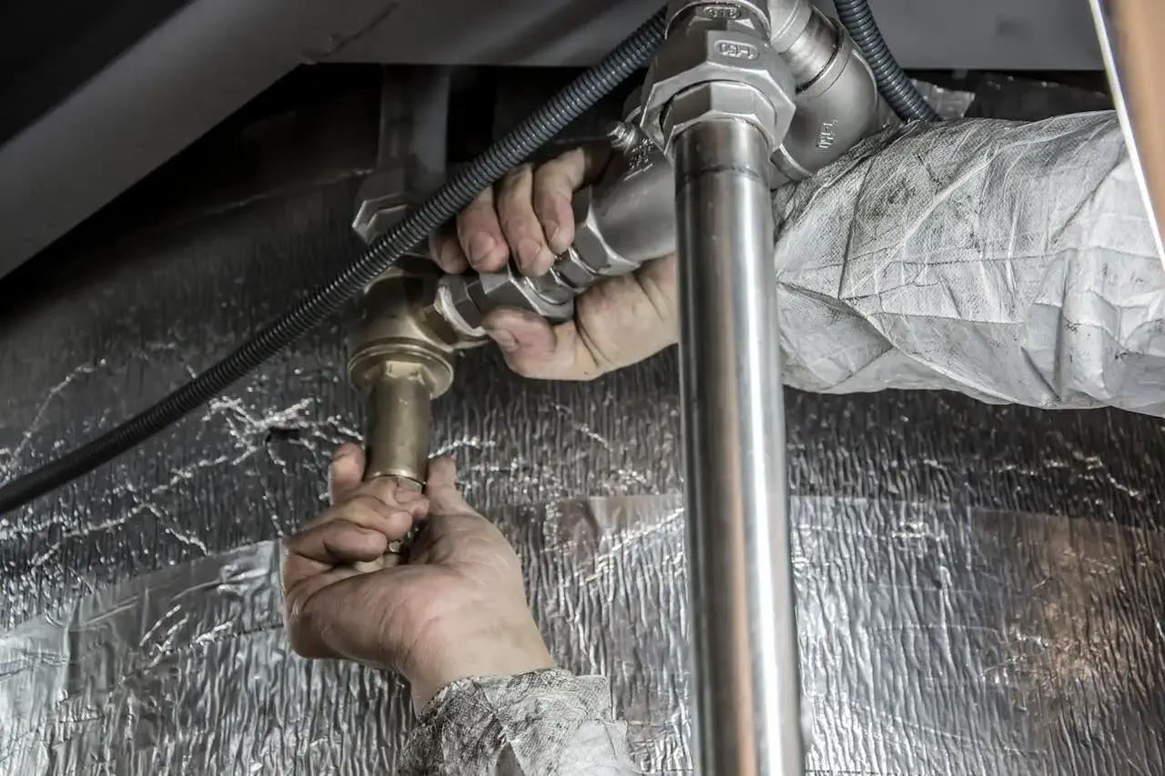 person performing plumbing maintenance